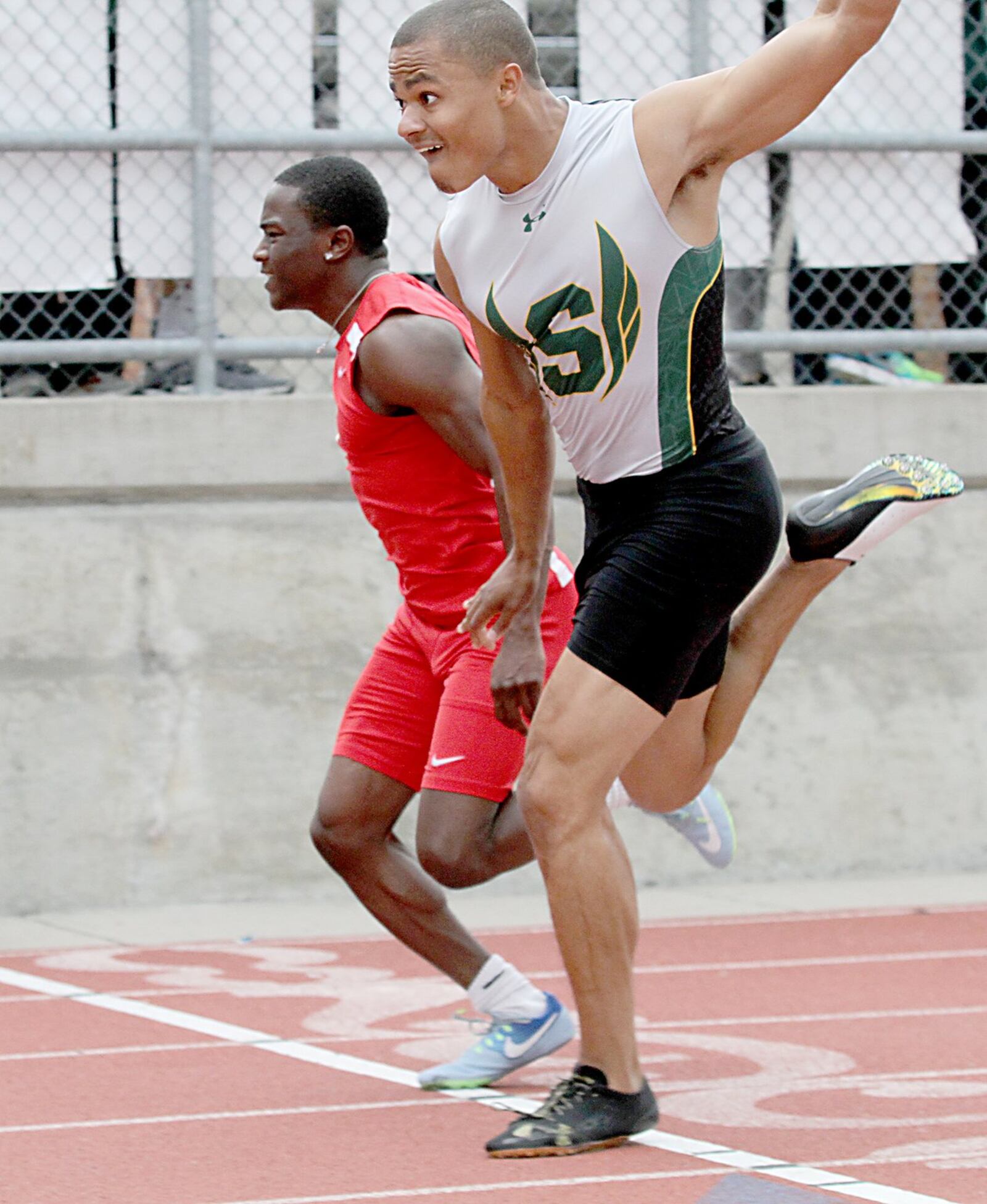 Fairfield’s Joe Hayes (left) finishes just behind Brenden Archer of Sycamore in the 100-meter dash during the Greater Miami Conference track & field meet on Dwire Field at Atrium Stadium in Mason on Friday. CONTRIBUTED PHOTO BY E.L. HUBBARD