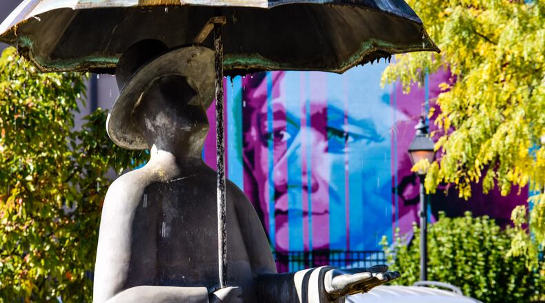 People taking "The Hammy Tours" in Hamilton will see the "Alexander" StreetSpark mural by Nicole Trimble and the "When It Rains It Pours" statue by Miles Metzger on Main Street, near True West Coffee. NICK GRAHAM/FILE