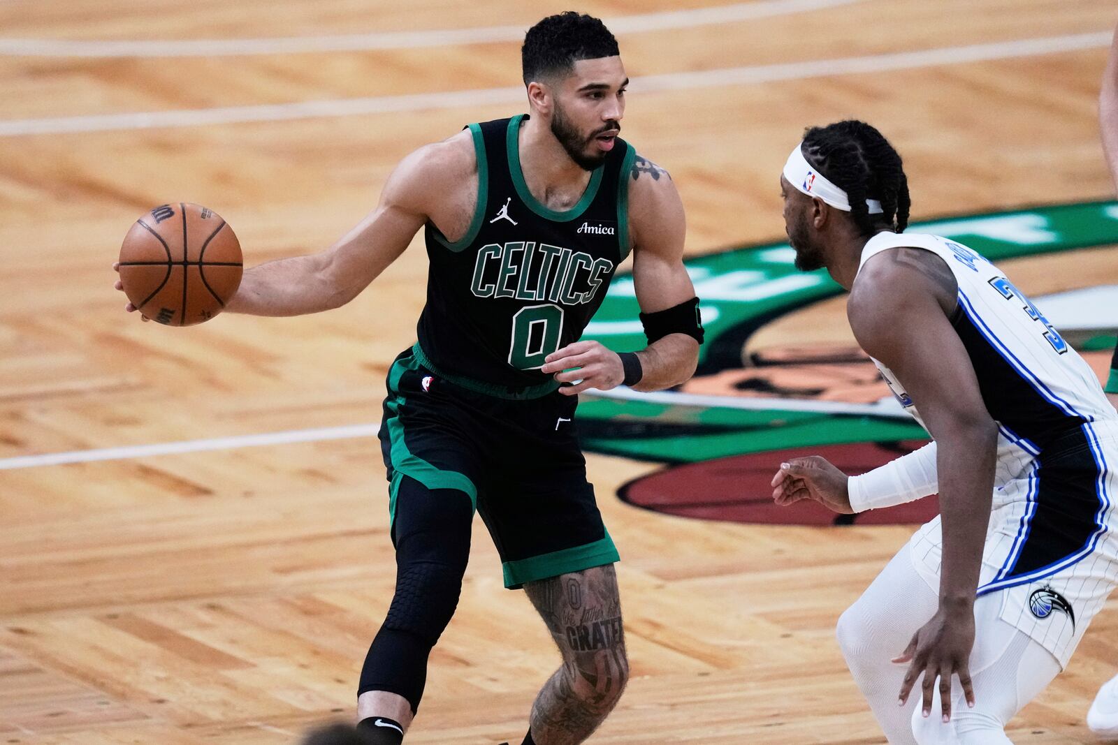 Boston Celtics forward Jayson Tatum (0) drives to the basket against Orlando Magic center Wendell Carter Jr. (34) during the first half in Game 5 of a first-round NBA playoff basketball series, Tuesday, April 29, 2025, in Boston. (AP Photo/Charles Krupa)