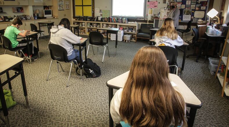 Oakwood Junior High students listen to English teacher Ann Whitehair's lecture Nov. 30. The school has been has been using the same plan all year where students attend half-days, five days a week.