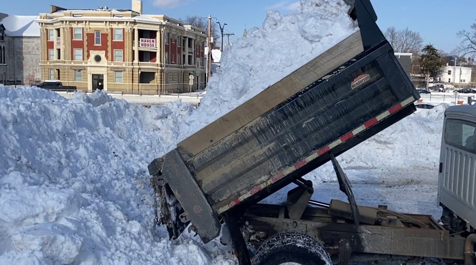 CAPTION: Hamilton crews dump snow into a designated city-owned lot off of High Street following a winter storm that saw more than a foot of snow fall Sunday, Jan. 25, 2026. Public Works Director Dan Arthur said between 300,000 to 500,000 cubic feet of snow has been moved to the lot, helping motorists and pedestrians more easily navigate city streets. CONTRIBUTED: TvHamilton