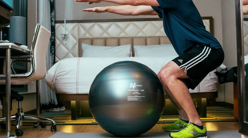 James Giannantonio, a 31-year-old Philadelphian, exercises in his room at Even Hotels Times Square South, in New York, Feb. 15, 2017. (Annie Tritt/The New York Times)