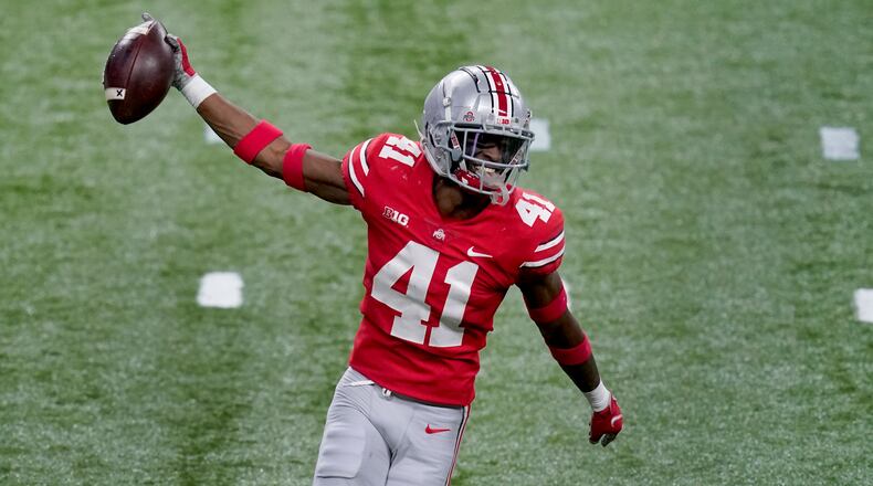 Ohio State safety Josh Proctor celebrates after intercepting a pass during the second half of the Big Ten championship NCAA college football game against Northwestern, Saturday, Dec. 19, 2020, in Indianapolis. (AP Photo/Darron Cummings)