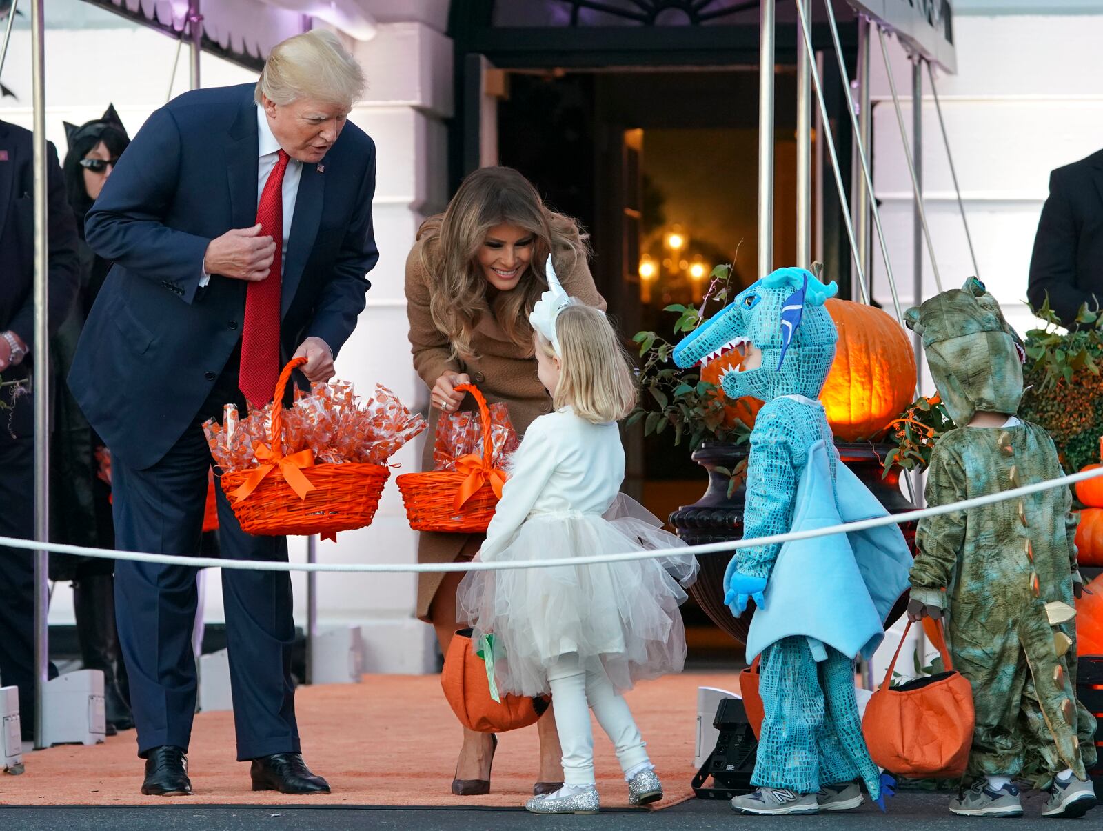 President Donald Trump and first lady Melania Trump hand out treats as they welcome children from the Washington area and children of military families to trick-or-treat celebrating Halloween at the South Lawn of the White House in Washington, Monday, Oct. 30, 2017. (AP Photo/Pablo Martinez Monsivais)