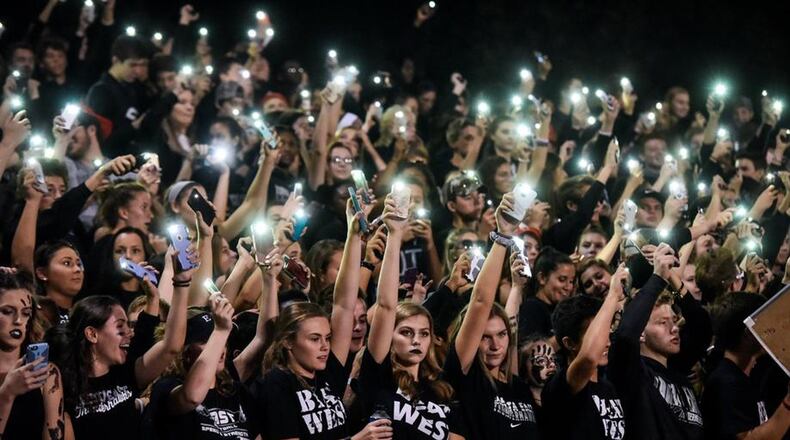 Lakota East football fans light up the night during a 35-0 win at Lakota West on Sept. 29, 2017, in West Chester Township. NICK GRAHAM/STAFF