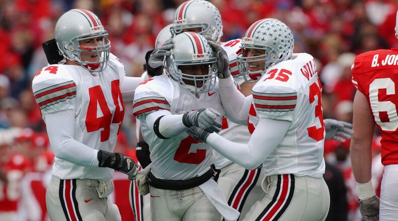 MADISON, WI - OCTOBER 19: Safety Mike Doss #2 of Ohio State celebrates a fumble recovery with linebacker teammates Matt Wilhelm #35 and Robert Reynolds #44 during the NCAA football game against Wisconsin at Camp Randall Stadium in Madison, Wisconsin on October 19, 2002. The Ohio State Buckeyes defeated the Wisconsin Badgers 14 - 19. (Photo by Jonathan Daniel /Getty Images)