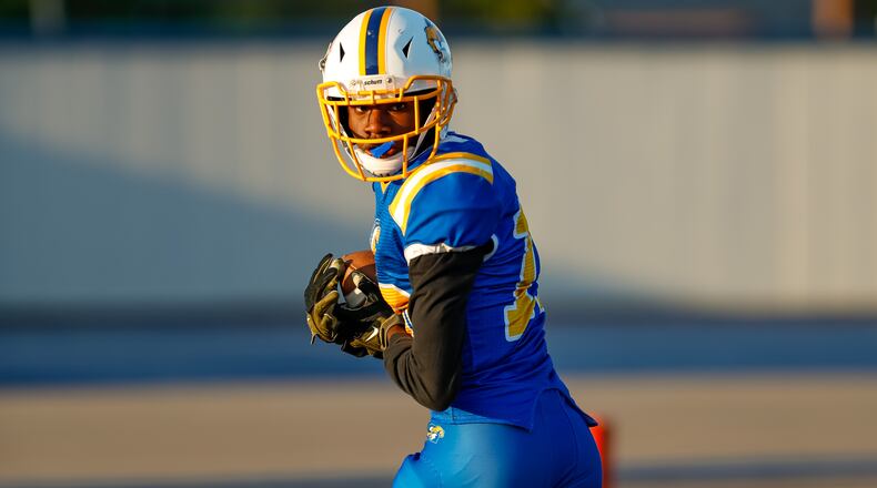 Cutline 2: Ponitz High School's Jahfunte Jackson looks back as he runs into the end zone during their game against Carroll on Thursday, Aug. 22 at Dayton Welcome Stadium. Michael Cooper/CONTRIBUTED