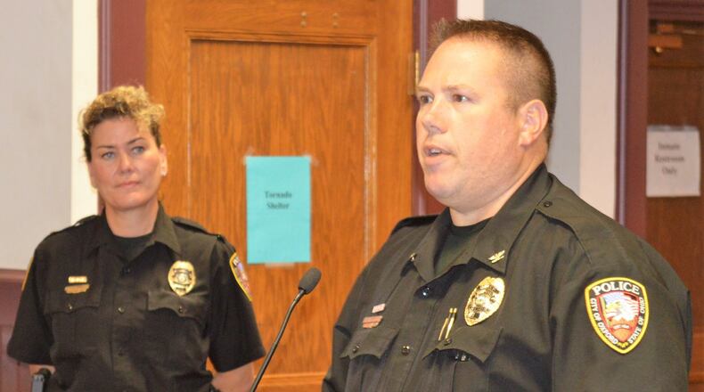 Oxford Police Lt. Lara Fening listens as Oxford Police Chief John Jones reads the certificate for a Meritorious Service Award presented to her in recognition of a life-saving effort she made following a vehicle crash on I-70 in June. CONTRIBUTED/BOB RATTERMAN