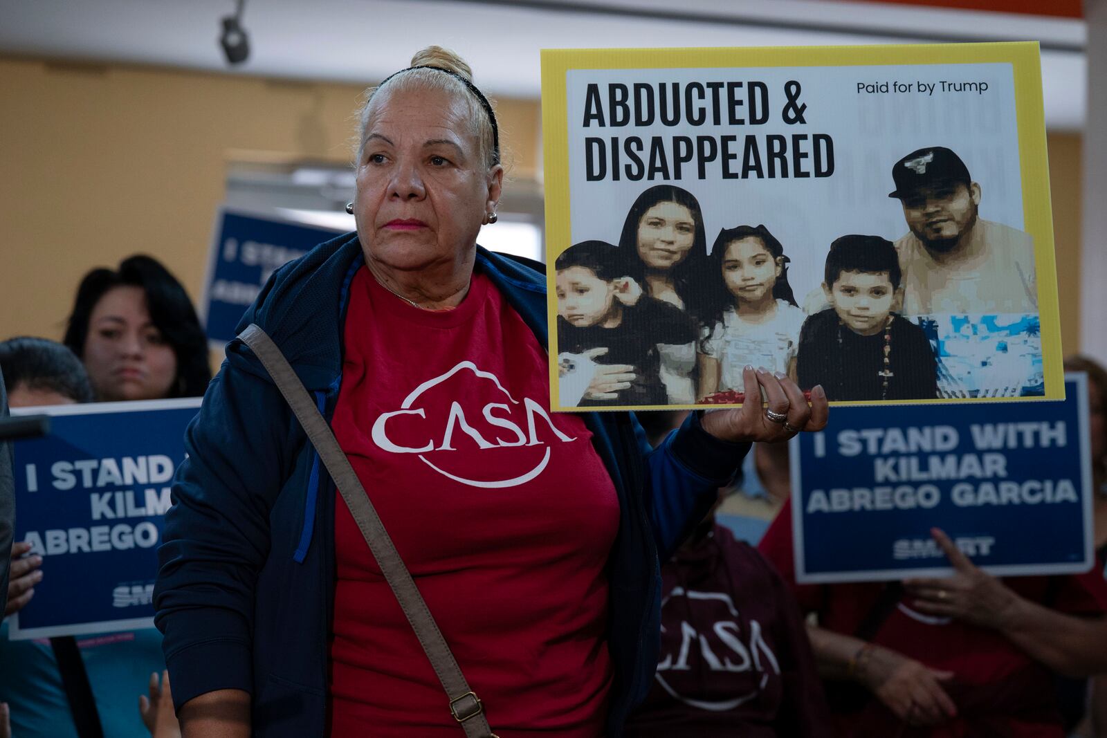 Supporters hold up signs as Jennifer Vasquez Sura, the wife of Kilmar Abrego Garcia of Maryland, who was mistakenly deported to El Salvador, speaks during a news conference at CASA's Multicultural Center in Hyattsville, Md., Friday, April 4, 2025. (AP Photo/Jose Luis Magana)