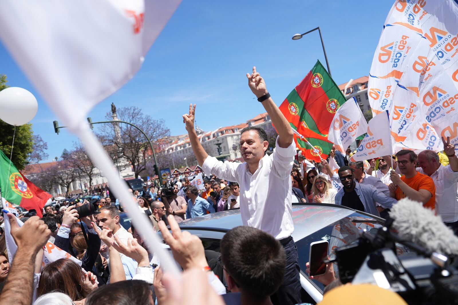 Incumbent Prime Minister and leader of the center-right Social Democratic Party Luis Montenegro gestures to supporters during an election campaign action in downtown Lisbon, Friday, May 16, 2025, ahead of the May 18 general election. (AP Photo/Ana Brigida)