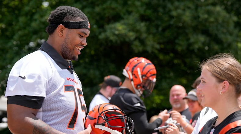 Cincinnati Bengals' Orlando Brown Jr. (75) signs autographs following an NFL football practice, Tuesday, June 4, 2024, in Cincinnati. (AP Photo/Jeff Dean)
