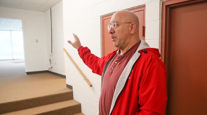 Ross Twp. Administrator Bob Bass gives a tour of the old Tragesser car dealership on Ohio 128 where the township is moving their offices this weekend. GREG LYNCH / STAFF