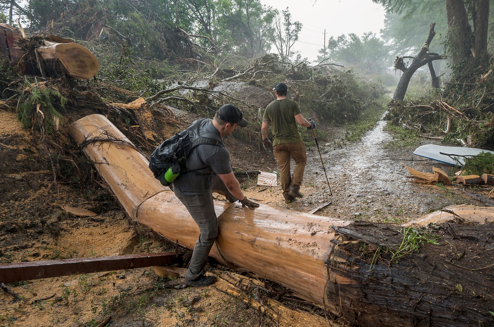 Volunteers search for missing people along the banks of the Guadalupe River after recent flooding on Sunday, July 6, 2025, in Hunt, Texas. (AP Photo/Rodolfo Gonzalez)