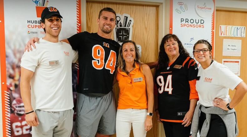 Cincinnati Bengals defensive End Sam Hubbard has The Sam Hubbard Foundation with the mission of tackling food insecurity in the Tri-State. Hubbard is seen here second from left. CONTRIBUTED