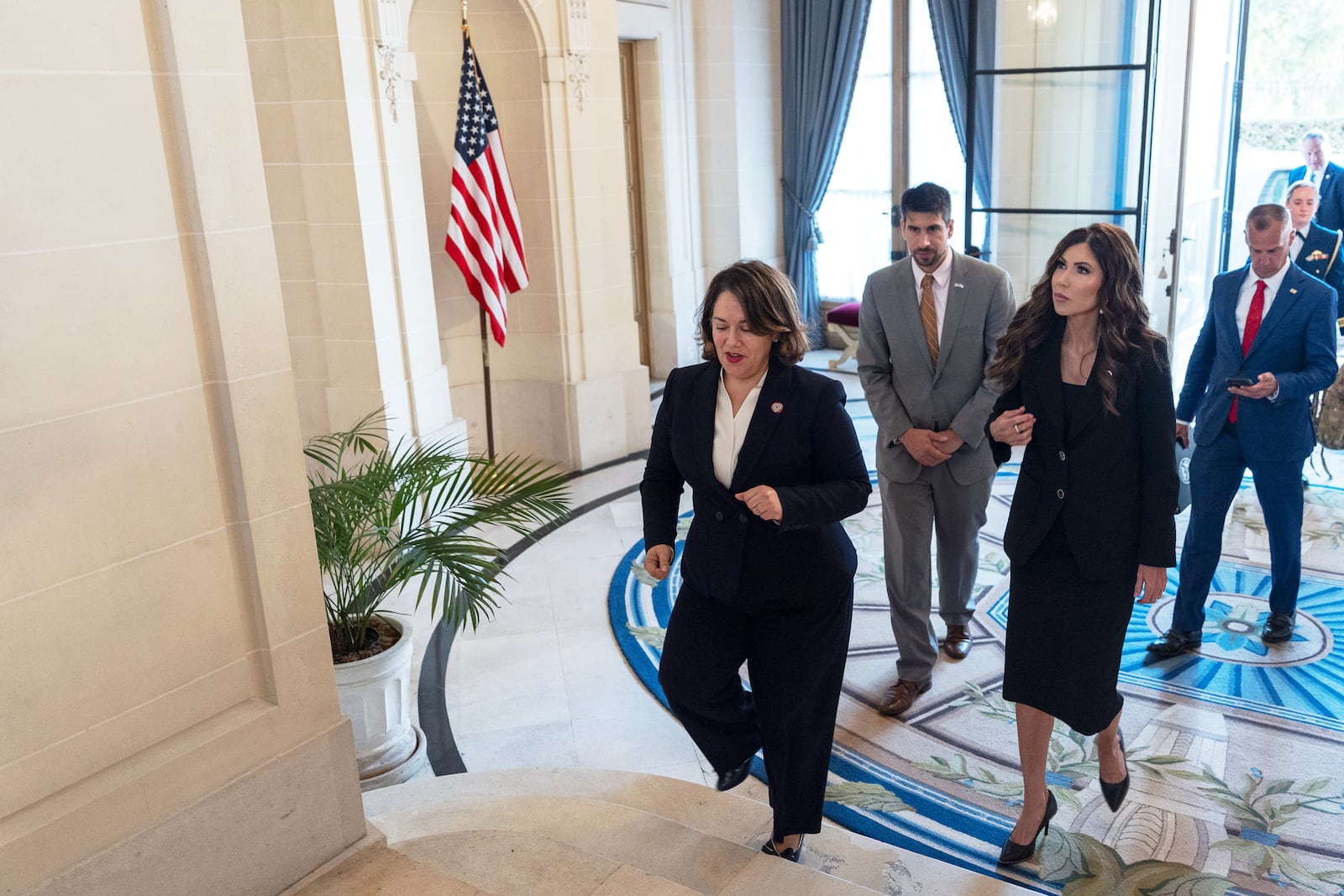 Homeland Security Secretary Kristi Noem, second from right, walks with U.S. Embassy Charge d'Affaires Heidi Gomez, left, as she arrives at the Bosch Palace Monday, July 28, 2025, in Buenos Aires, Argentina. (AP Photo/Alex Brandon, Pool)