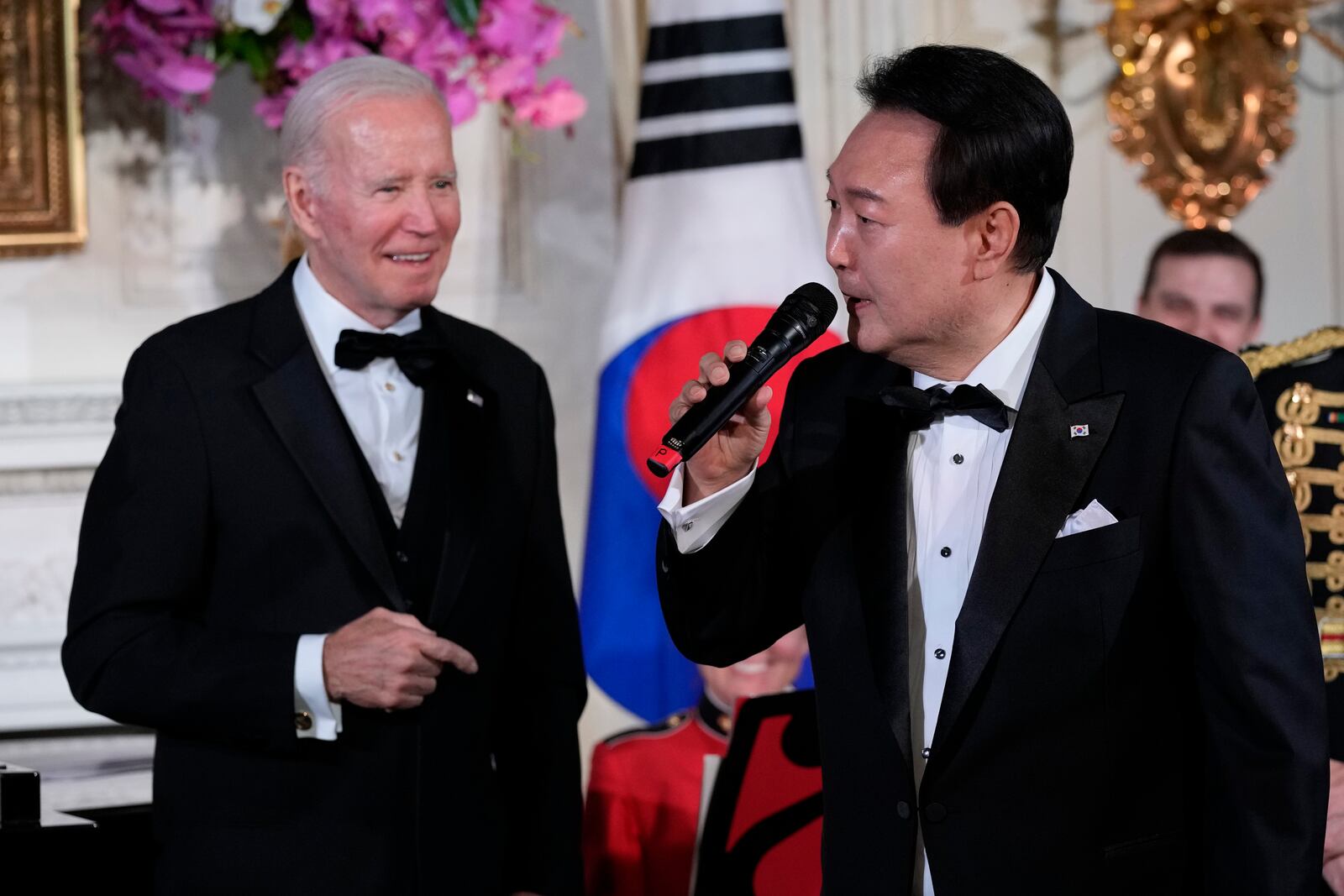 FILE - President Joe Biden listens as South Korea's President Yoon Suk Yeol sings the song American Pie by Don Mclean in the State Dining Room of the White House in Washington, on April 26, 2023, following the State Dinner. (AP Photo/Susan Walsh, File)