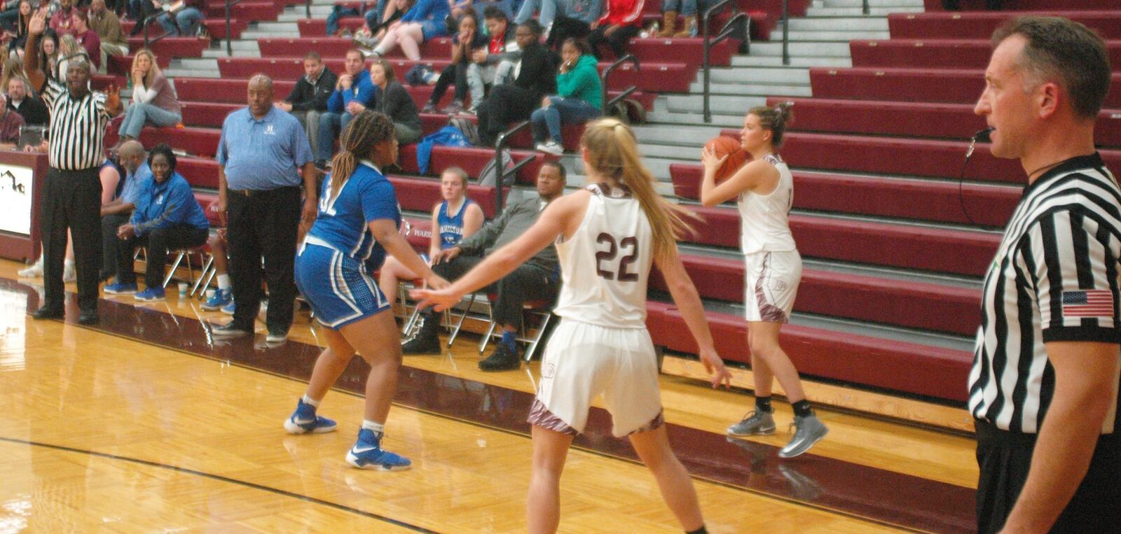 Lebanon’s Ashley West prepares to throw an inbounds pass as teammate Logan Mueller (22) and Hamilton’s Kira Ash (32) watch Monday night at Lebanon. Visiting Big Blue won 52-42. RICK CASSANO/STAFF