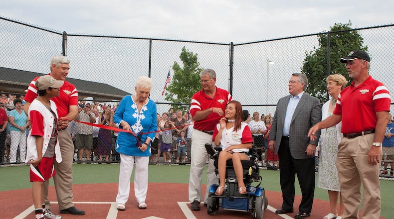 From left, Jessi Hutson of Hamilton, project coordinator Steve Smith, Joe Nuxhall's widow Donzetta, Larry Tischler, Miracle League ambassador Karlee Thomas, and Bonnie and Kim Nuxhall cut the ribbon at the June 2012 dedication of the Joe Nuxhall Miracle League field. FILE PHOTO