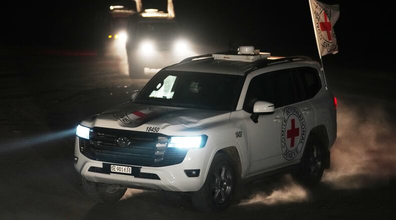 Red Cross vehicles carrying the bodies of three people believed to be deceased hostages handed over by Hamas make their way toward the border crossing with Israel, to be transferred to Israeli authorities, in Deir al-Balah, central Gaza Strip, Sunday, Nov. 2, 2025. (AP Photo/Jehad Alshrafi)