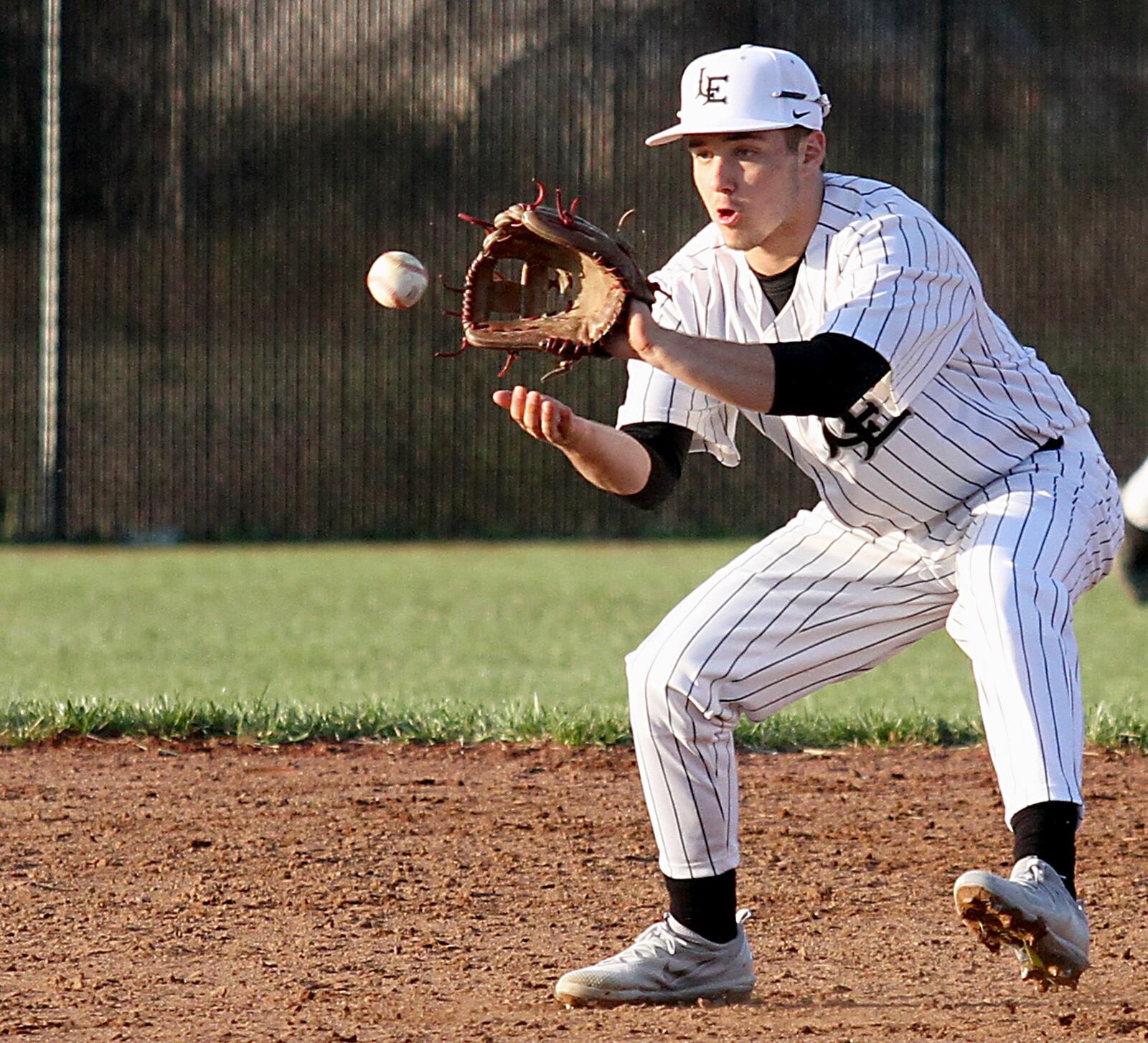 Lakota East’s Dylan Fry fields an Oak Hills ground ball during Tuesday’s game at East. CONTRIBUTED PHOTO BY E.L. HUBBARD