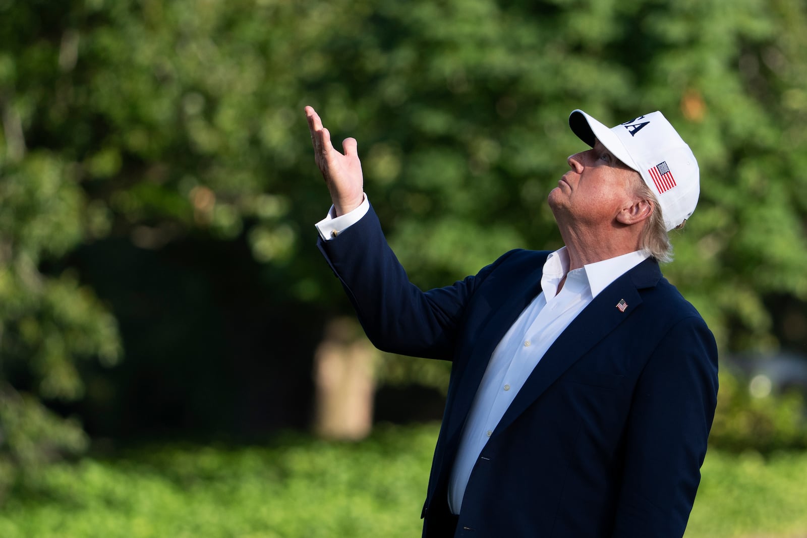 President Donald Trump looks up at the American flag on the flagpole on the South Lawn as he arrives at the White House, Sunday, July 6, 2025, in Washington. (AP Photo/Manuel Balce Ceneta)