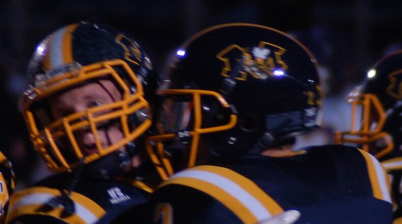 Monroe quarterback Nick Osterman (2) is congratulated by teammate Dakota Fannin after scoring a touchdown during Friday night’s game against visiting Bellbrook. CONTRIBUTED PHOTO BY JOHN CUMMINGS