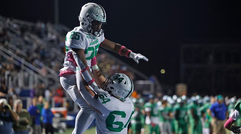 Badin's Drew Vocke lifts his teammate Lem Grayson into the air after he scored a touchdown during Friday's game at CJ. BILL LACKEY/STAFF