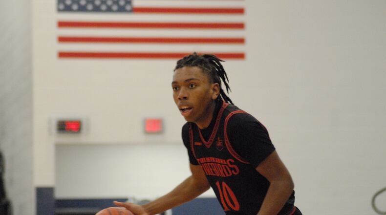 Lakota West senior Jason Lavender surveys the floor against Sycamore during a Division I sectional contest on Tuesday night at West Clermont. Lavender scored 12 points in the Firebirds' 55-47 loss. Chris Vogt/CONTRIBUTED