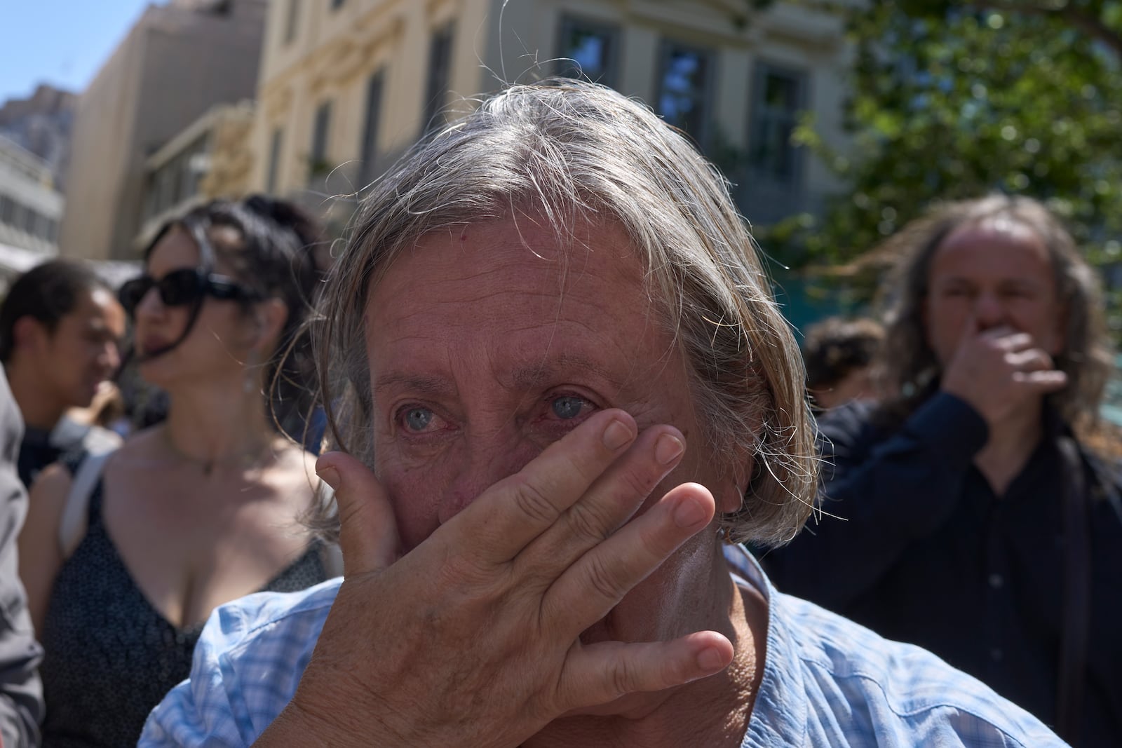 A woman weeps during a farewell ceremony for renowned clarinetist Petroloukas Chalkias, who died at 90 over the weekend, at Athens Cathedral on Wednesday, June 18, 2025. (AP Photo/Petros Giannakouris)