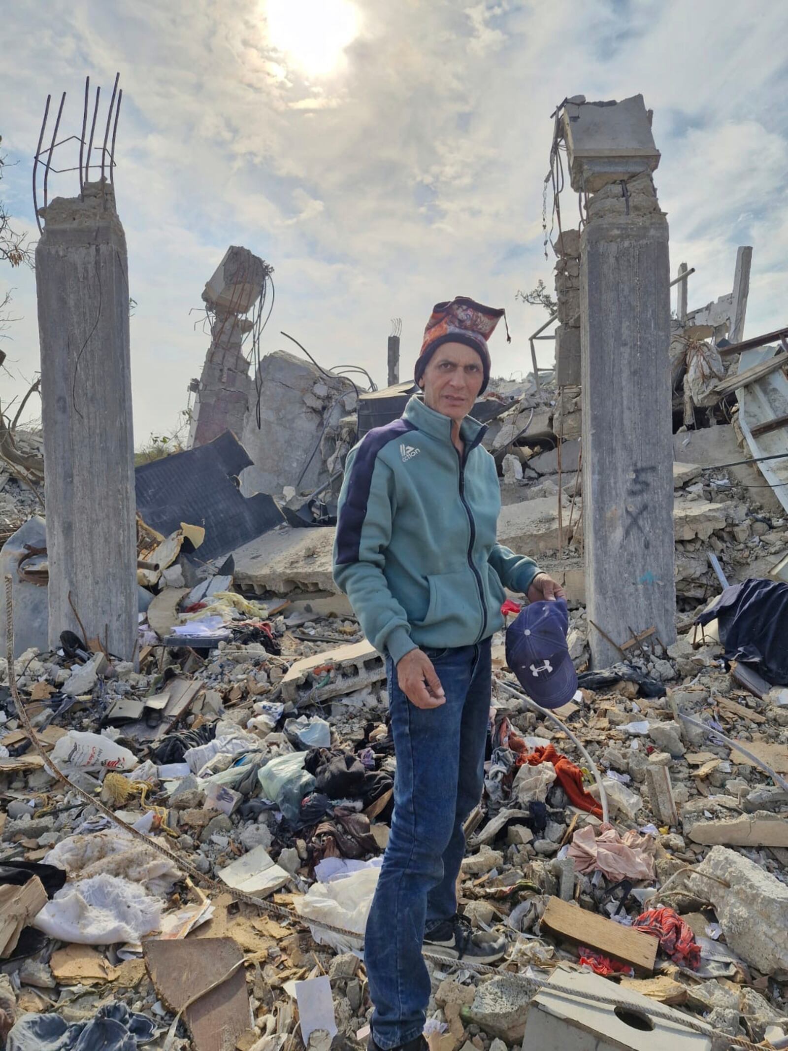This photo provided by Palestinian Nidal Alzaanin, shows him standing in front of his demolished home in Beit Hanoun, Gaza Strip, March, 2025. (AP Photo)