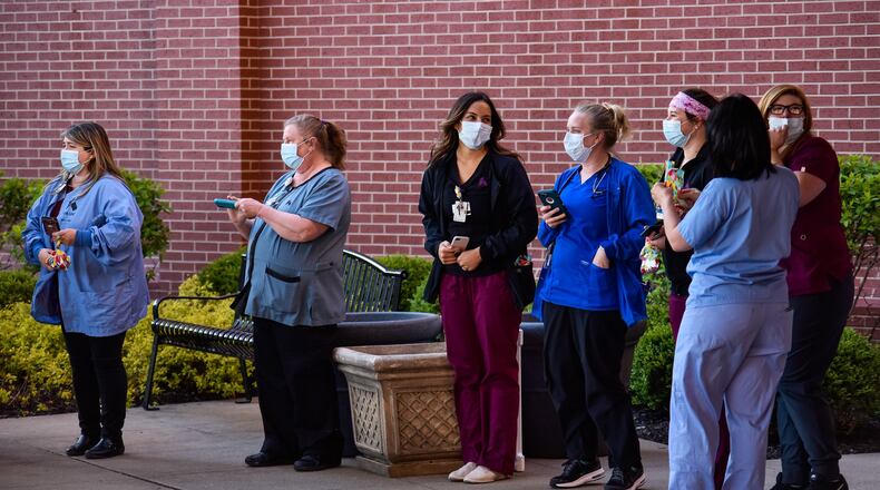 Police and Fire department vehicles from around Butler County lined up with emergency lights on to honor nurses, doctors and workers at Kettering Health Network’s Fort Hamilton Hospital Tuesday evening, April 21, 2020 in Hamilton. The same thing happened at many hospitals in the area. NICK GRAHAM / STAFF