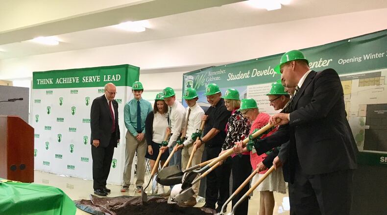 Officials from Hamilton’s Badin High School — joined by city and regional leaders — flipped ceremonial soil June 13 to mark the beginning of an $1.8 million campus expansion. MICHAEL D. CLARK/STAFF