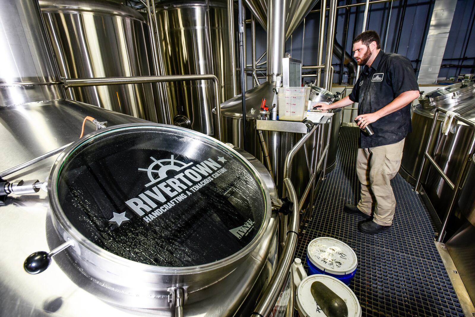 Brewer Charles Taylor tends to the brewing process at Rivertown Brewery & Barrel House in Monroe.