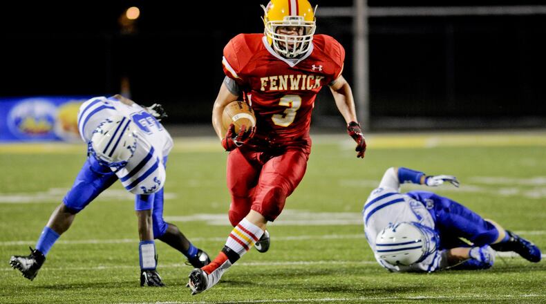 Fenwick’s Frank Catrine carries the ball during a Skyline Chili Crosstown Showdown game against Wyoming on Aug. 23, 2012, at Sycamore. NICK GRAHAM/STAFF