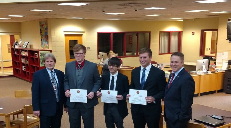 Three Ross High School students have won top, Congressional district honors by inventing a mobile device app that helps needy families find food pantries. Ross High School IT computer science instructor Tom O’Neill (left) recently joined Ross students (left to right) Kyle Inderhees, Gunner Nonnamaker, and Jacob Kahmann who was visited by Congressman Warren Davidson, R-Troy.