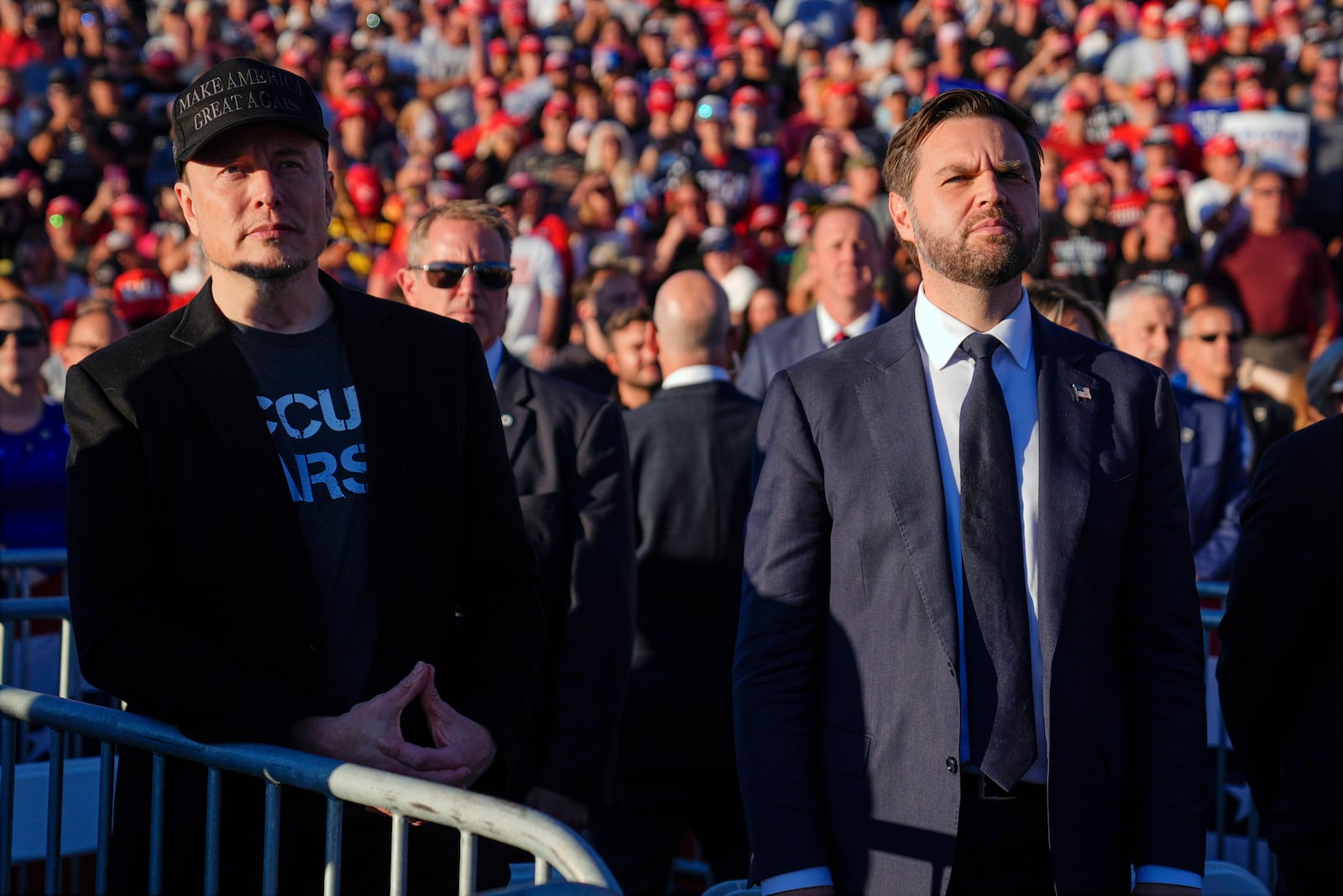 FILE - Elon Musk, left, and Republican vice presidential nominee Sen. JD Vance, R-Ohio, listen as Republican presidential nominee former President Donald Trump speaks at a campaign rally, Oct. 5, 2024, in Butler, Pa. (AP Photo/Evan Vucci, File)