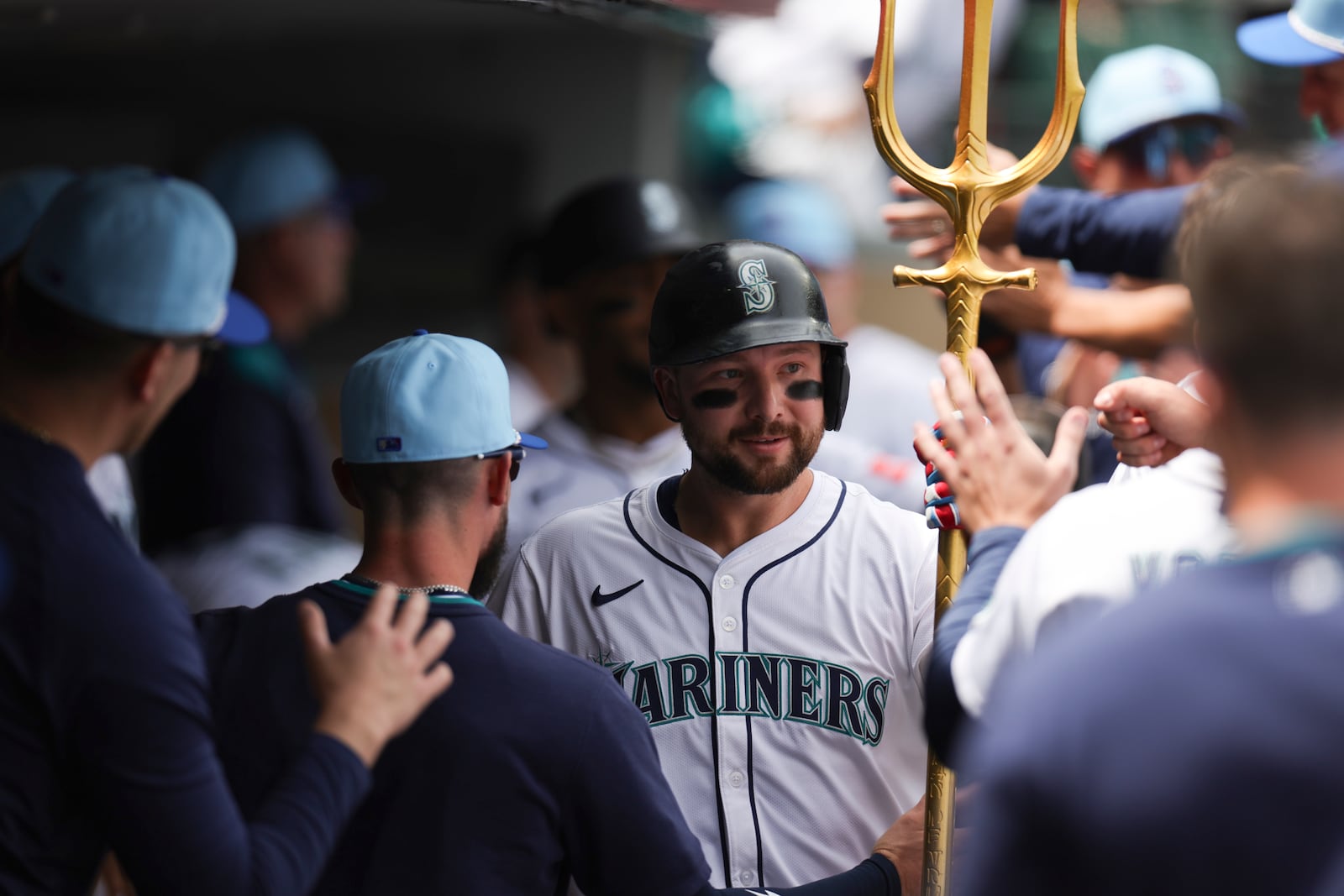 Seattle Mariners designated hitter Cal Raleigh, center, celebrates in the dugout after hitting a two-run home run during the first inning of a baseball game against the Pittsburgh Pirates, Friday, July 4, 2025, in Seattle. (AP Photo/Ryan Sun)