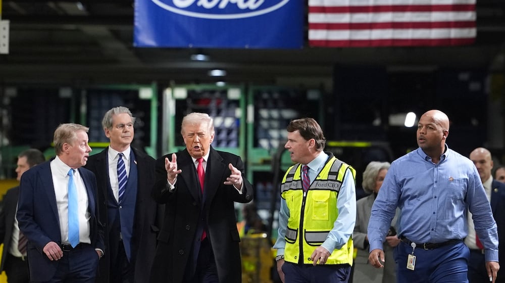 President Donald Trump speaks to, from left Bill Ford, Executive Chairman of Ford, Treasury Secretary Scott Bessent, Jim Farley, CEO of Ford, and Corey Williams, Ford River Rouge Plant Manager, during a tour of the Ford River Rogue complex, Tuesday, Jan. 13, 2026, in Dearborn, Mich. (AP Photo/Evan Vucci)