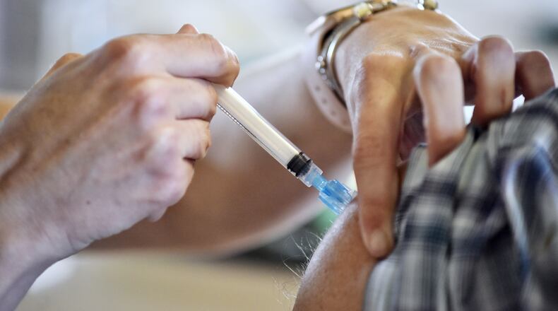 A COVID-19 shot is administered locally. The virus is seeing a rise, again, as numbers show Butler County being high since May. NICK GRAHAM/FILE