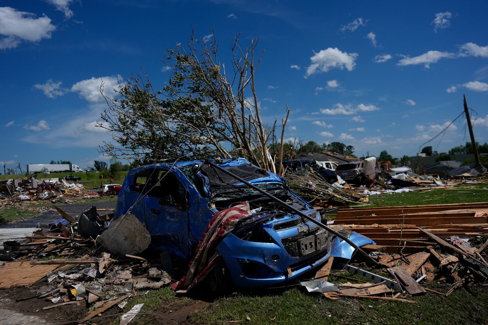 A vehicle is covered in debris after a severe storm passed the area on Saturday, May 17, 2025 in London, Ky. (AP Photo/Carolyn Kaster)
