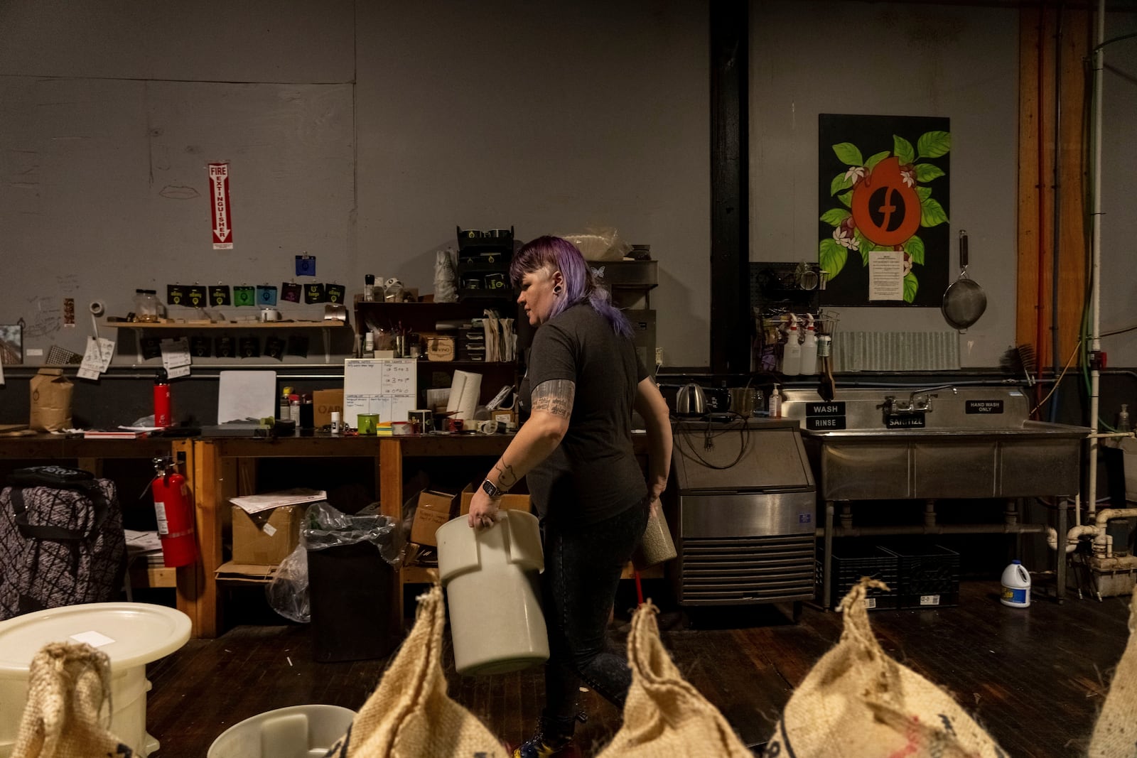 Renee Colon, co-owner of Fuego Coffee Roasters, works at her roasting facility Friday, March 21, 2025, in Rochester, N.Y. (Max Conway via AP)