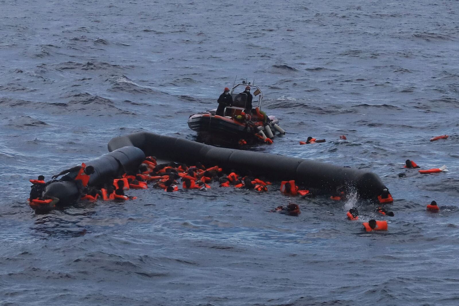 FILE - Refugees and migrants are rescued by members of the Spanish NGO Proactiva Open Arms in the Mediterranean Sea on Nov. 11, 2020. (AP Photo/Sergi Camara, File)