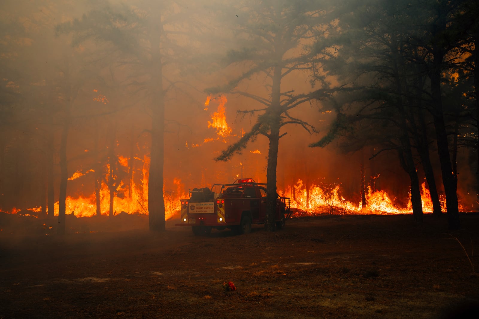 Firefighters battle a wildfire in Ocean County, N.J. on Thursday, April 24, 2025. (New Jersey Department of Environmental Protection via AP)