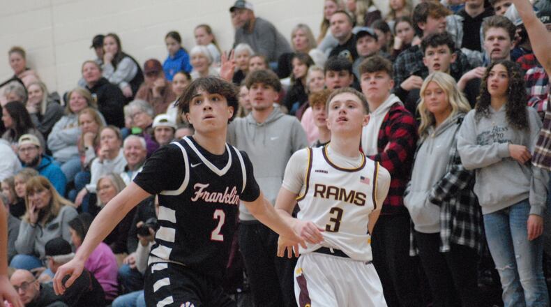 Ross senior Isaac Nunn (3) follows through after taking a shot as Franklin junior Kai Cook (2) boxes out on Friday night. Chris Vogt/CONTRIBUTED