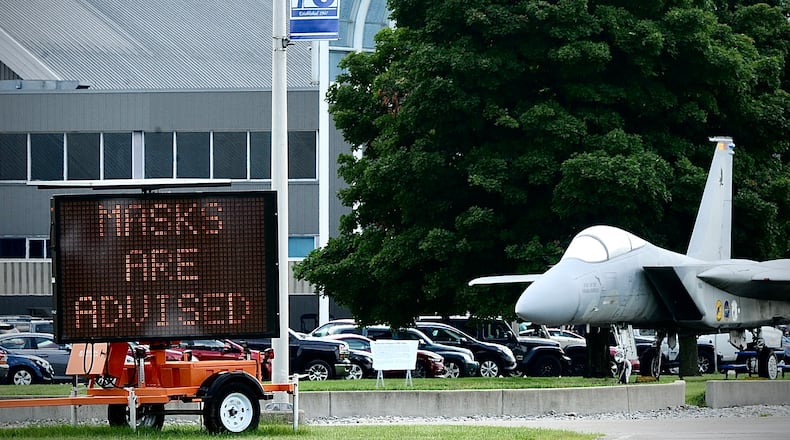 Signs outside the National Museum of the U.S. Air Force remind visitors that masks are recommended inside due to rising COVID levels. MARSHALL GORBY / STAFF