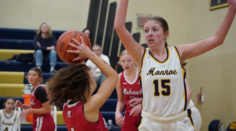 Monroe's Ryan Buskirk (15) defends Madison's Malerie Bobbitt (1) on Thursday night at Monroe High School. Chris Vogt/CONTRIBUTED