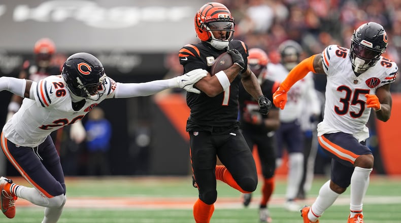 Chicago Bears cornerback Nahshon Wright (26), left, tries to grab Cincinnati Bengals wide receiver Ja'Marr Chase (1) as he runs the ball during the first half of an NFL football game, Sunday, Nov. 2, 2025, in Cincinnati. (AP Photo/Jeff Dean)