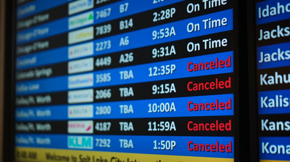 A flight status screen shows canceled flights to the Dallas-Fort Worth, Texas, area from the Salt Lake City International Airport amid a winter storm Saturday, Jan. 24, 2026, in Salt Lake City. (AP Photo/Sydney Schaefer)