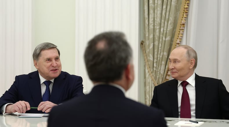 Russian President Vladimir Putin, right, and Russian Presidential foreign policy adviser Yuri Ushakov, left, attend the talks with U.S. special envoy Steve Witkoff, back to a camera, at the Senate Palace of the Kremlin in Moscow, Russia, Tuesday, Dec. 2, 2025. (Alexander Kazakov, Sputnik, Kremlin Pool Photo via AP)