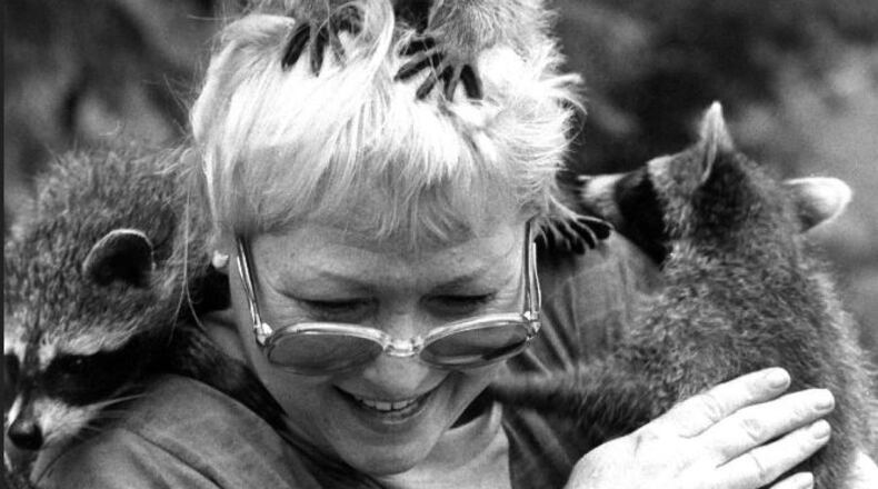 Mary Hamen and her raccoon friends in this 1987 photo.